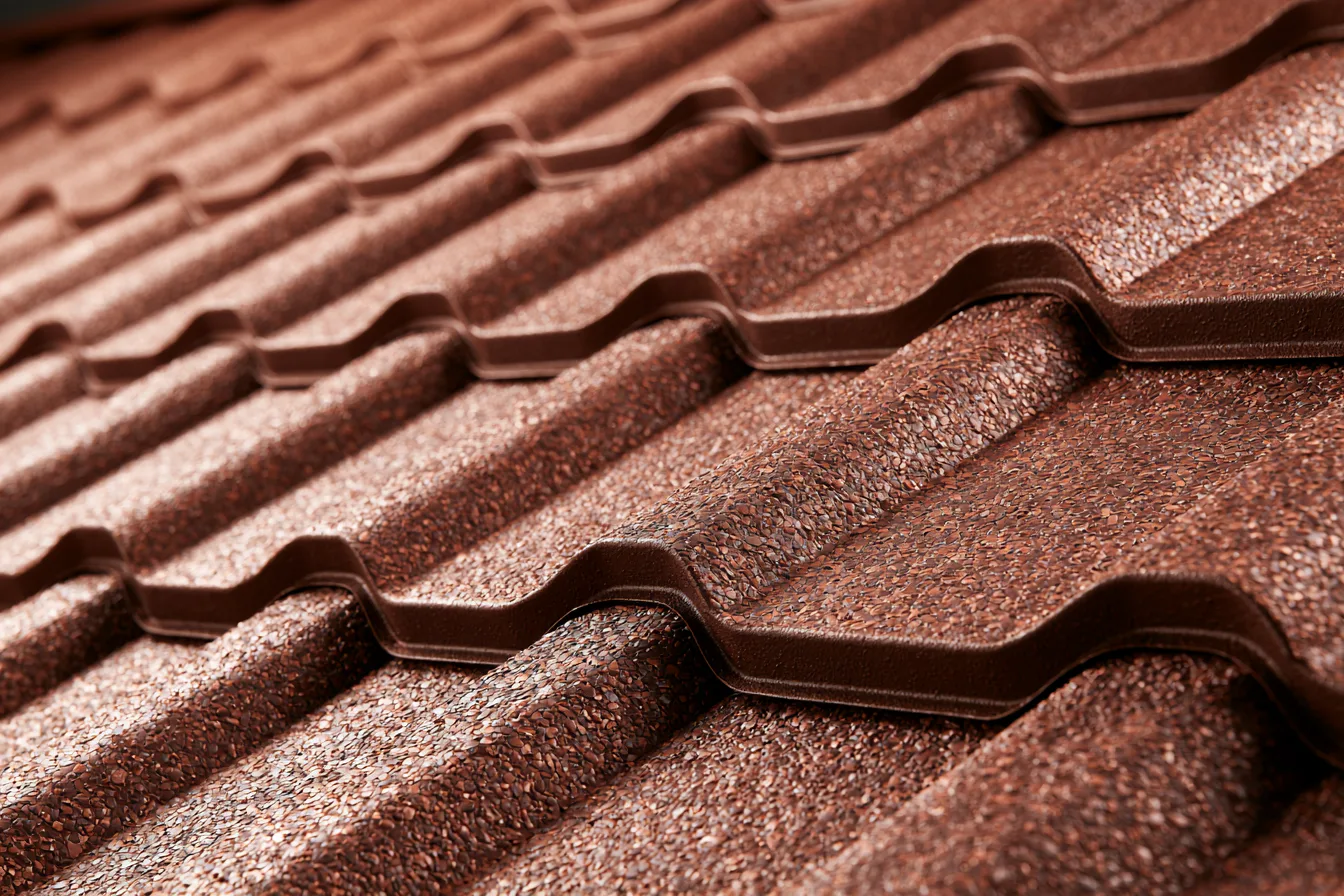 Red-brown stone-coated steel roofing formed into a tile-like profile